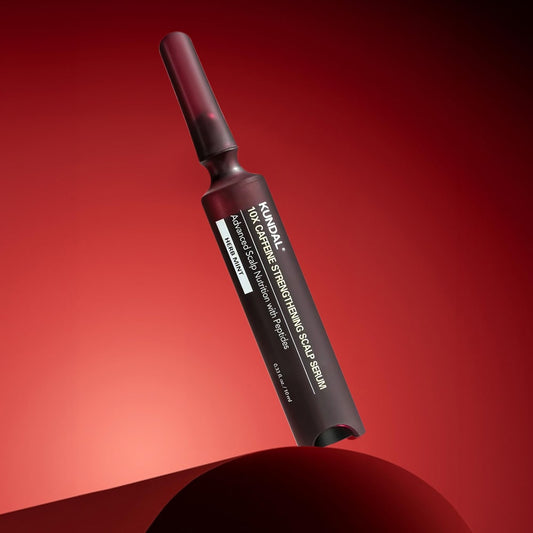 Kundal scalp serum bottle on a red background