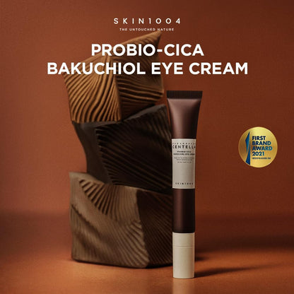 SKIN1004 Probio-Cica Bakuchiol Eye Cream tube on a brown background with decorative elements.