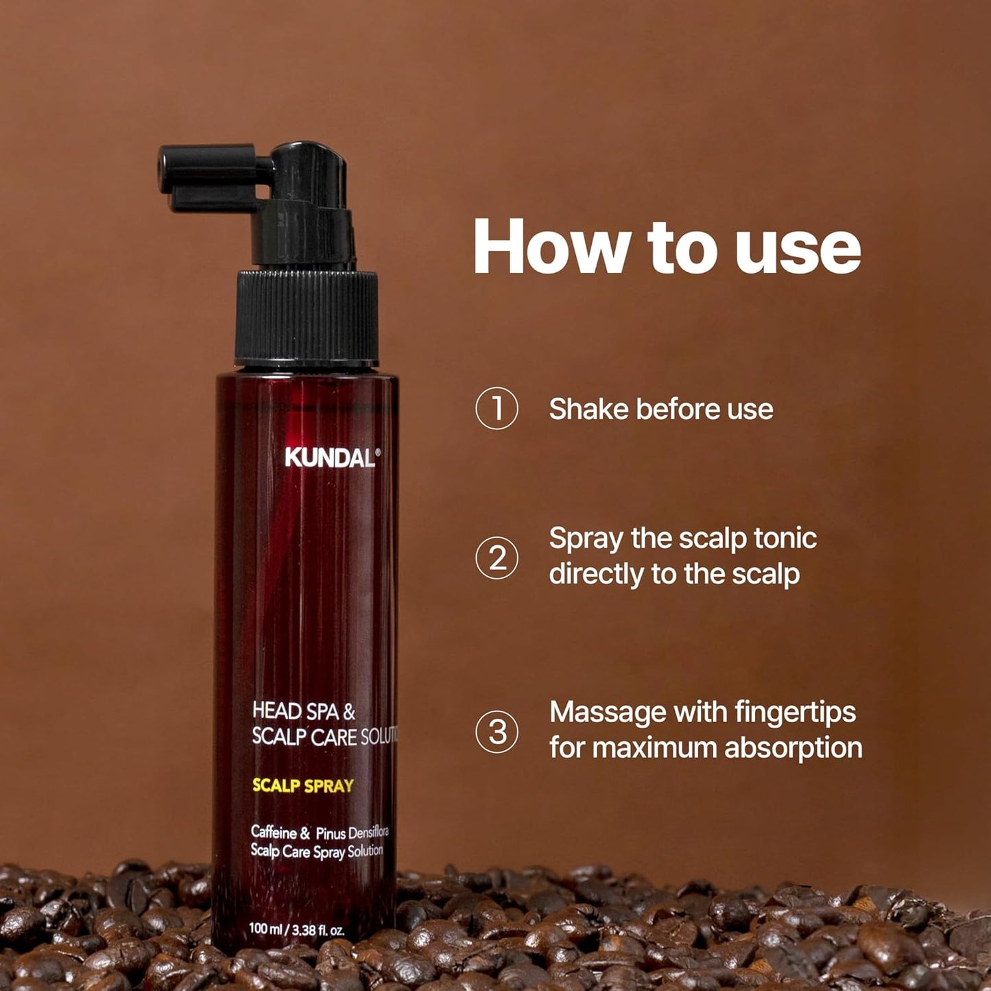 Kundal scalp spray bottle with usage instructions on a brown background