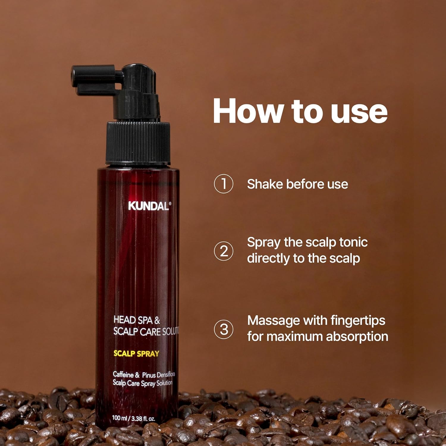 Kundal scalp spray bottle with usage instructions on a brown background