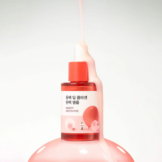 Pink bottle with red cap on a white background