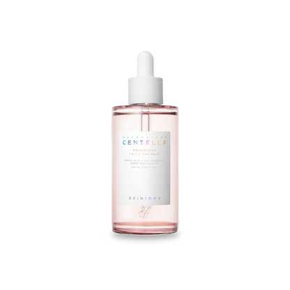 Skincare serum bottle with a white cap on a white background