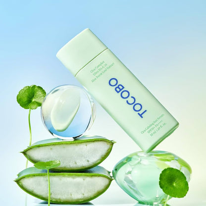 Tocobo skincare product with aloe vera slices on a light blue background