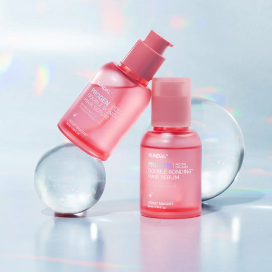 Two pink hair serum bottles on a reflective surface with a light blue gradient background