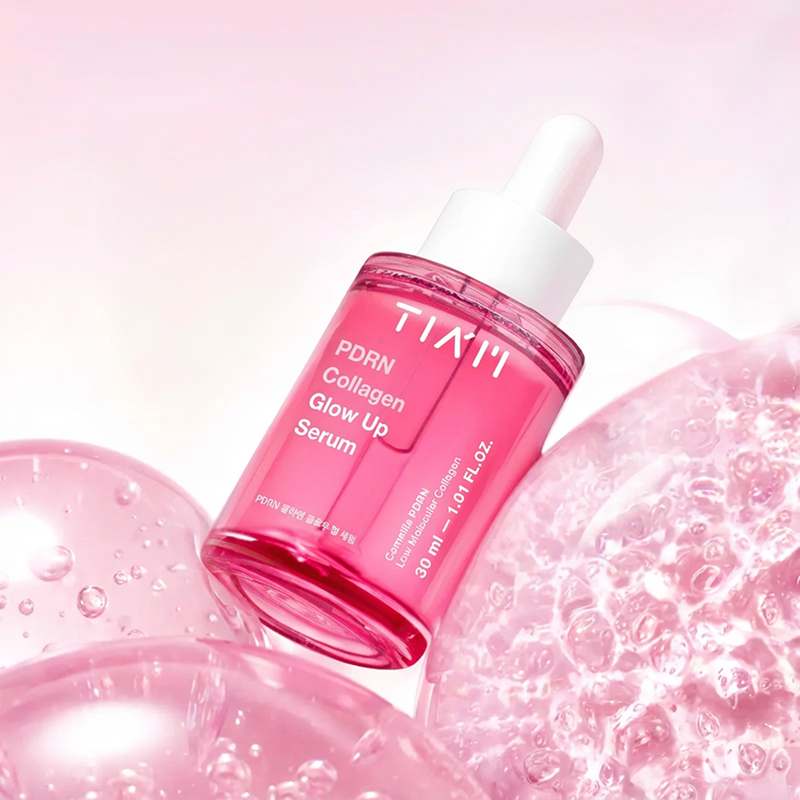 Pink serum bottle with dropper on a pink background