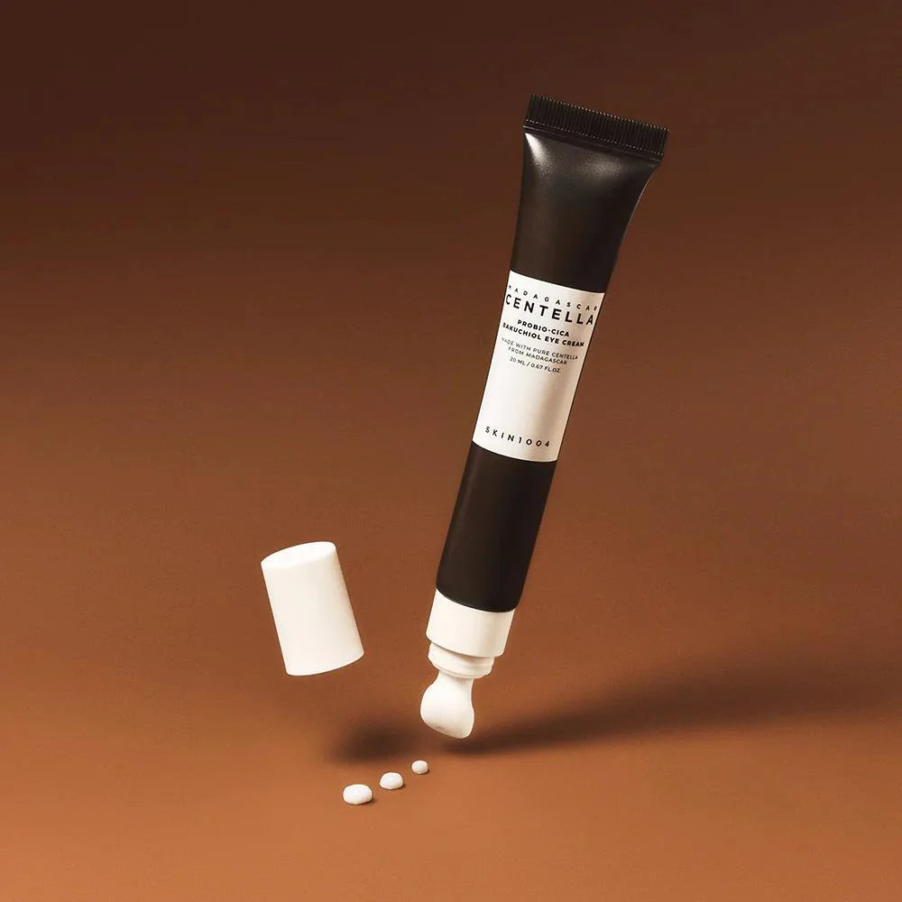 Skincare tube with applicator on a brown background