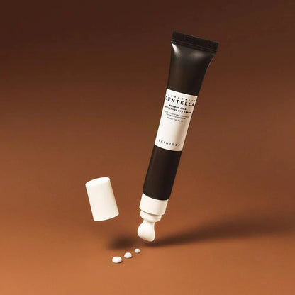 Skincare tube with applicator on a brown background